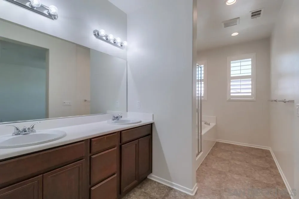 1257 Idanan Road, Unit 3 Chula Vista, CA 91913 - Photo 34 of 40 a bathroom with a double vanity sink and a mirror