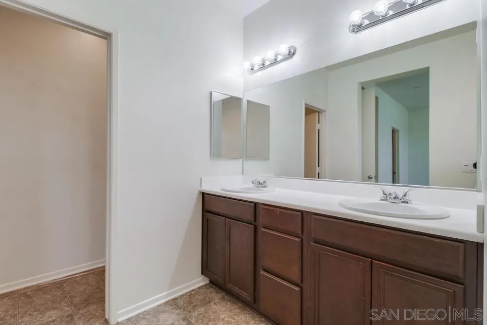 1257 Idanan Road, Unit 3 Chula Vista, CA 91913 - Photo 36 of 40 a bathroom with a double vanity sink and a mirror