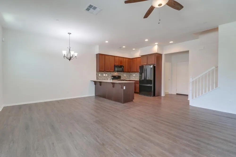 1257 Idanan Road, Unit 3 Chula Vista, CA 91913 - Photo 5 of 40 a kitchen with stainless steel appliances a refrigerator sink and cabinets