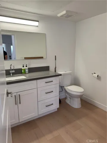 a bathroom with a toilet a sink and mirror
