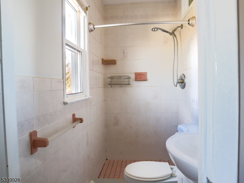 167 Marne Road Hopatcong, NJ 07843 - Photo 12 of 16 a white toilet sitting next to a bathroom sink