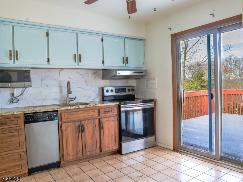167 Marne Road Hopatcong, NJ 07843 - Photo 14 of 16 a kitchen with stainless steel appliances granite countertop a sink and cabinets