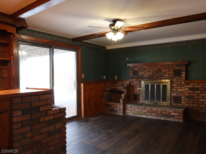 167 Marne Road Hopatcong, NJ 07843 - Photo 9 of 16 a living room with furniture and a fireplace