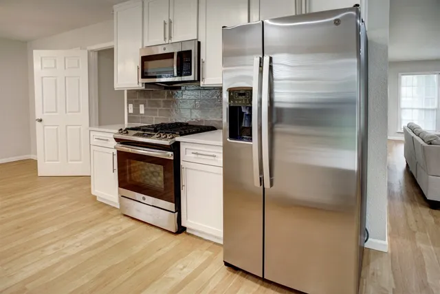 a kitchen with a refrigerator stove and microwave