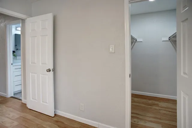 a view of a hallway with wooden floor
