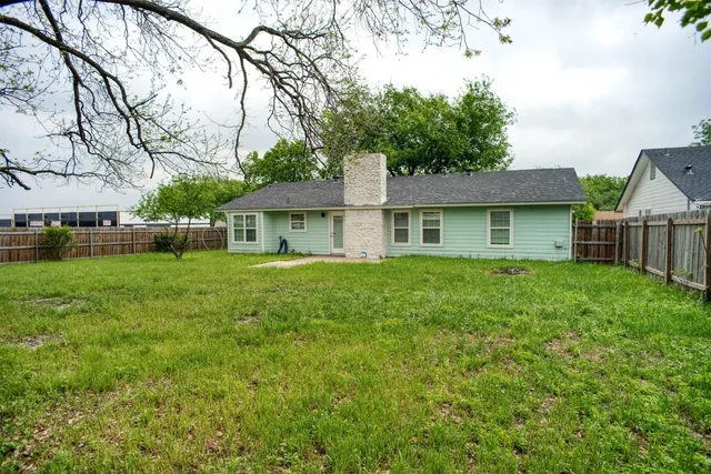 a front view of a house with yard and green space