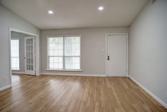 wooden floor in an empty room with a window