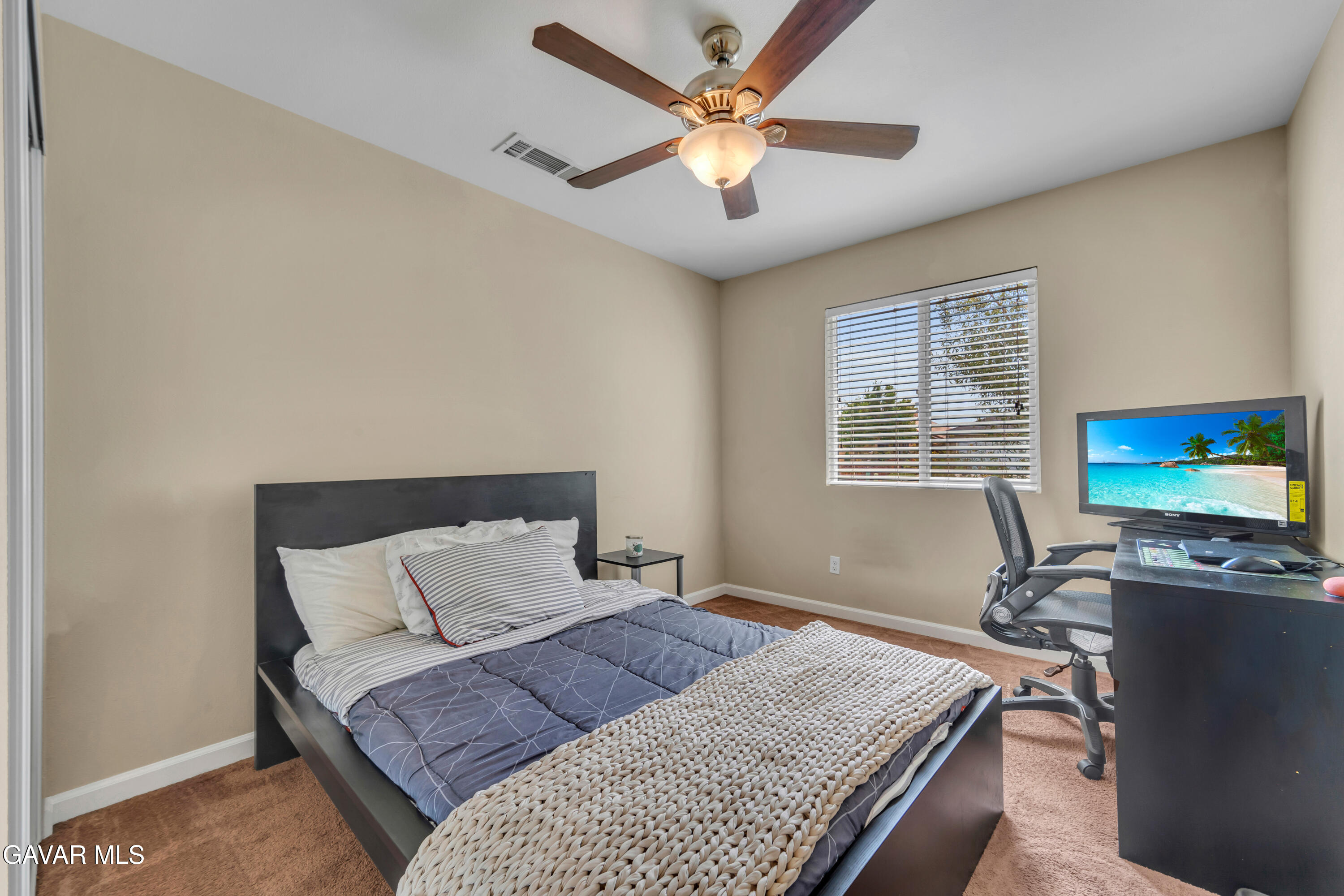 1415 Richfield Avenue Rosamond, CA 93560 - Photo 11 of 21 a bedroom with a bed and a desk