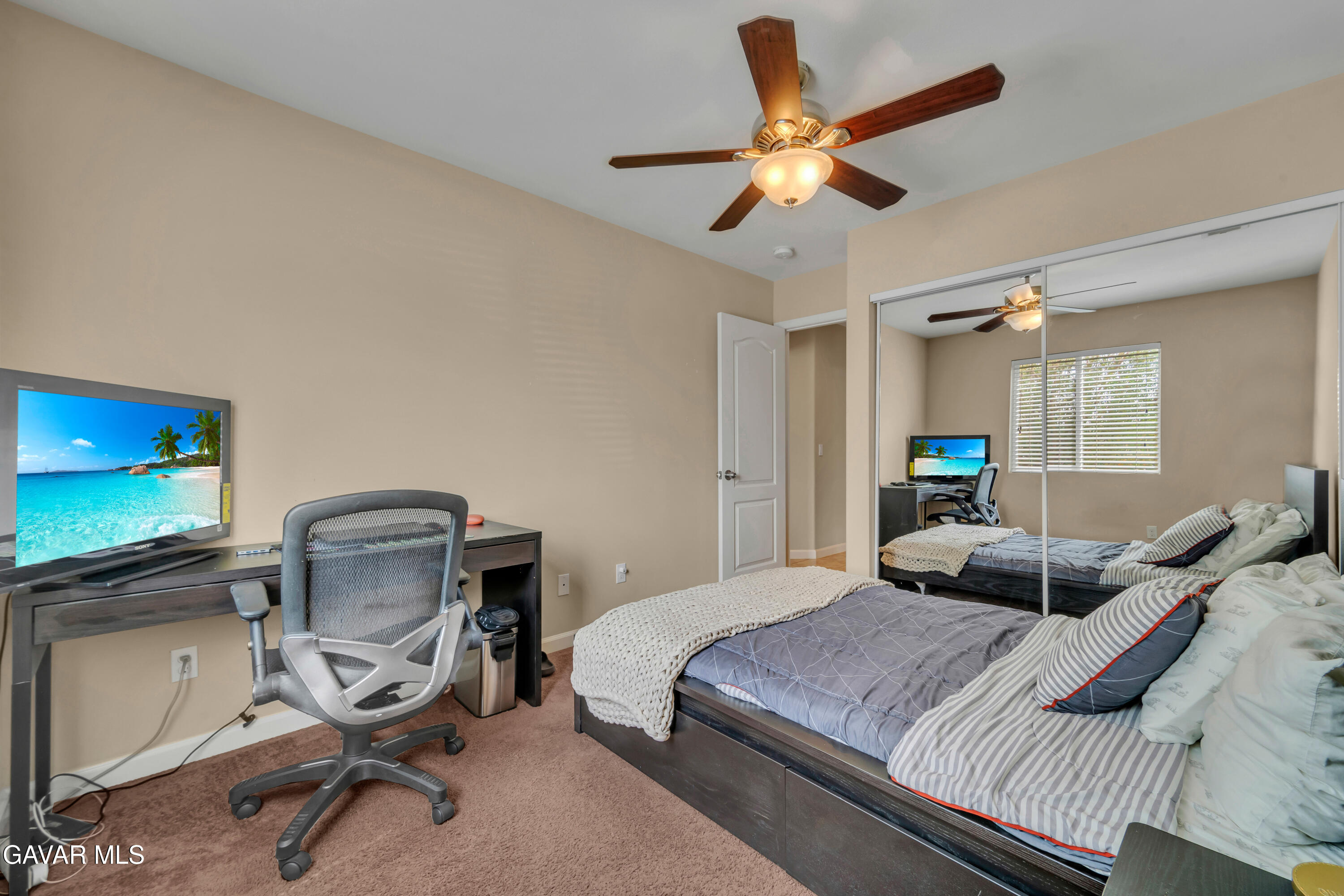 1415 Richfield Avenue Rosamond, CA 93560 - Photo 12 of 21 a bedroom with a bed a desk and chair