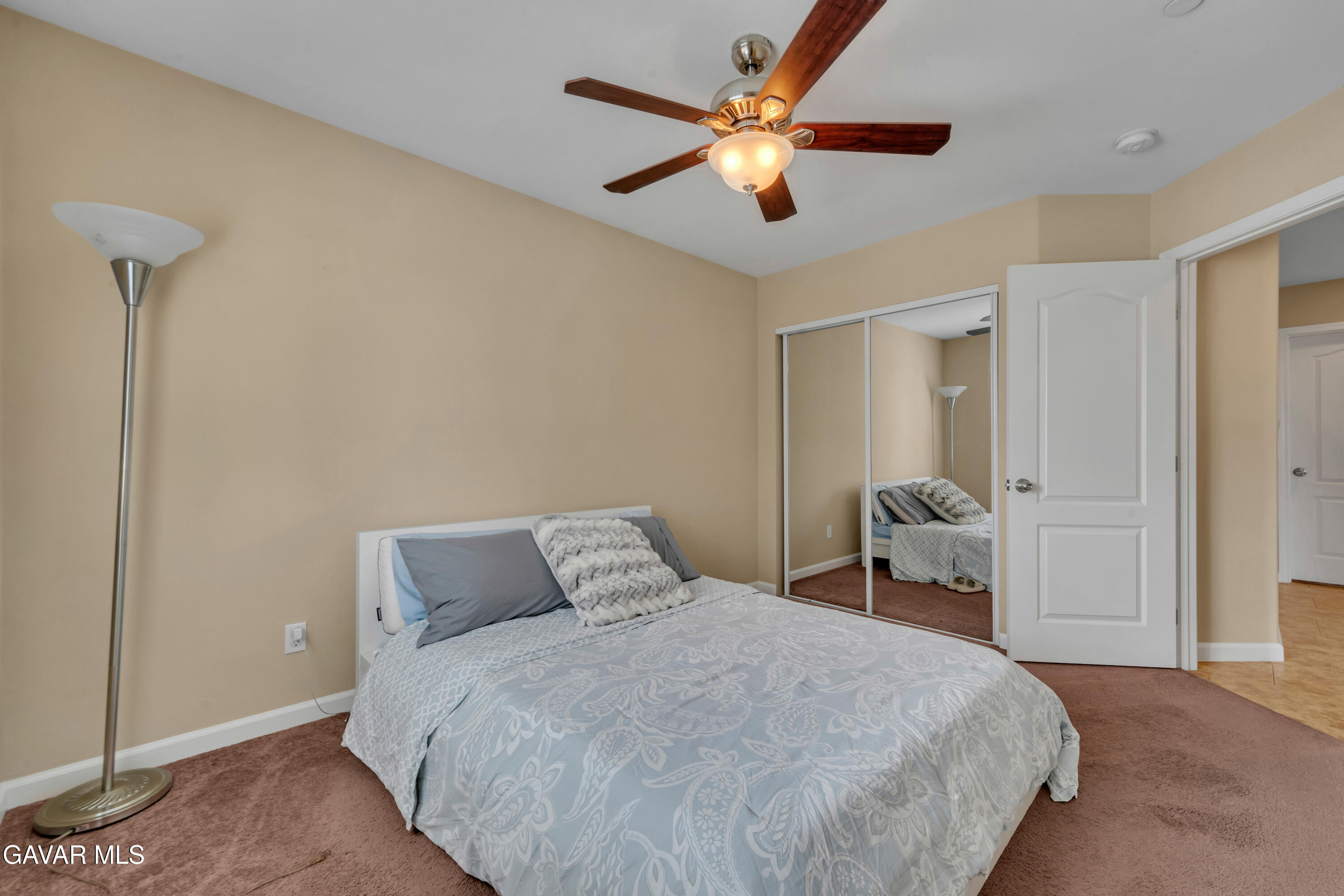 1415 Richfield Avenue Rosamond, CA 93560 - Photo 13 of 21 a bedroom with a bed and a ceiling fan