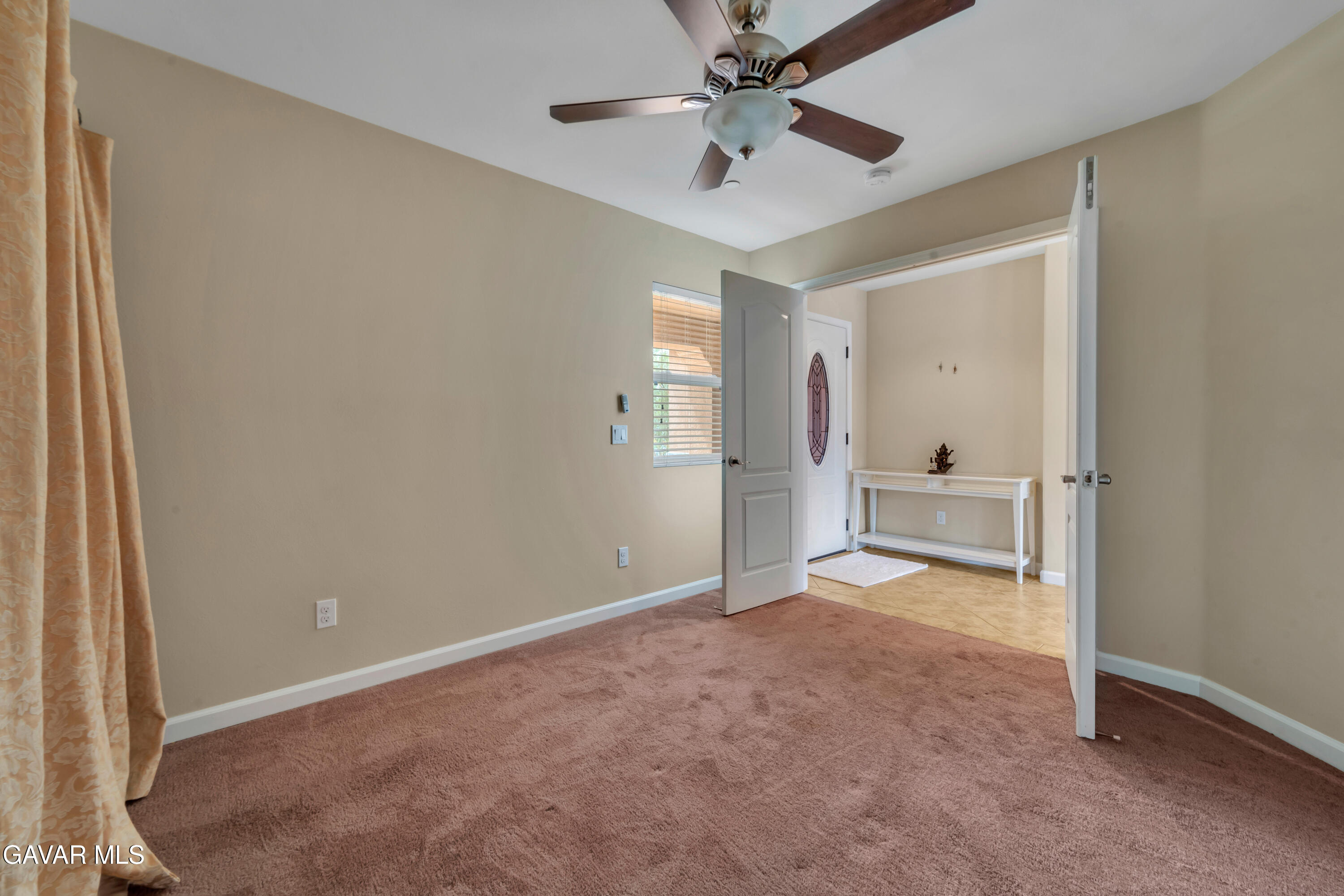 1415 Richfield Avenue Rosamond, CA 93560 - Photo 14 of 21 an empty room with fan and entrance