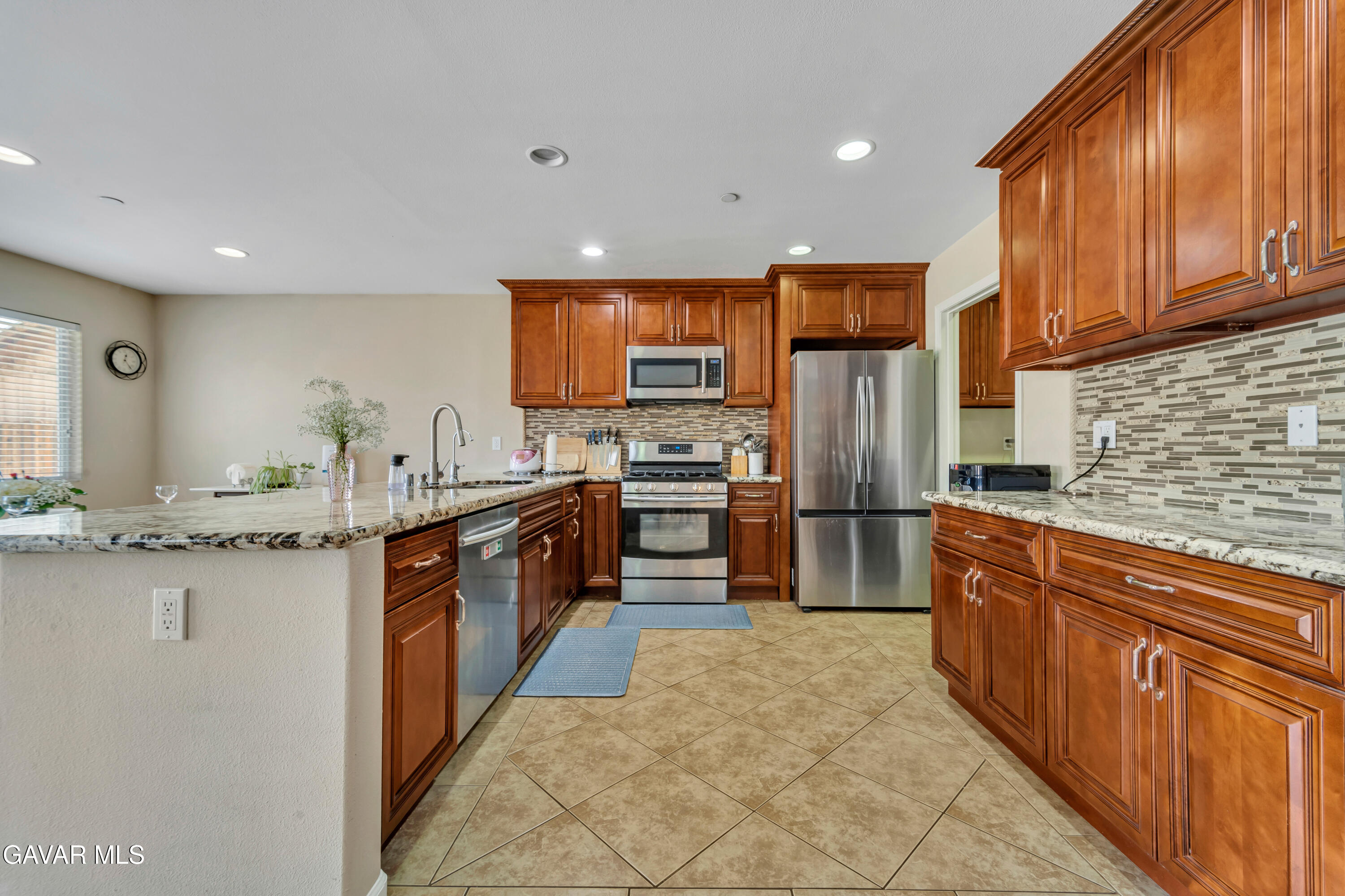 1415 Richfield Avenue Rosamond, CA 93560 - Photo 3 of 21 a large kitchen with stainless steel appliances granite countertop a refrigerator and a stove top oven