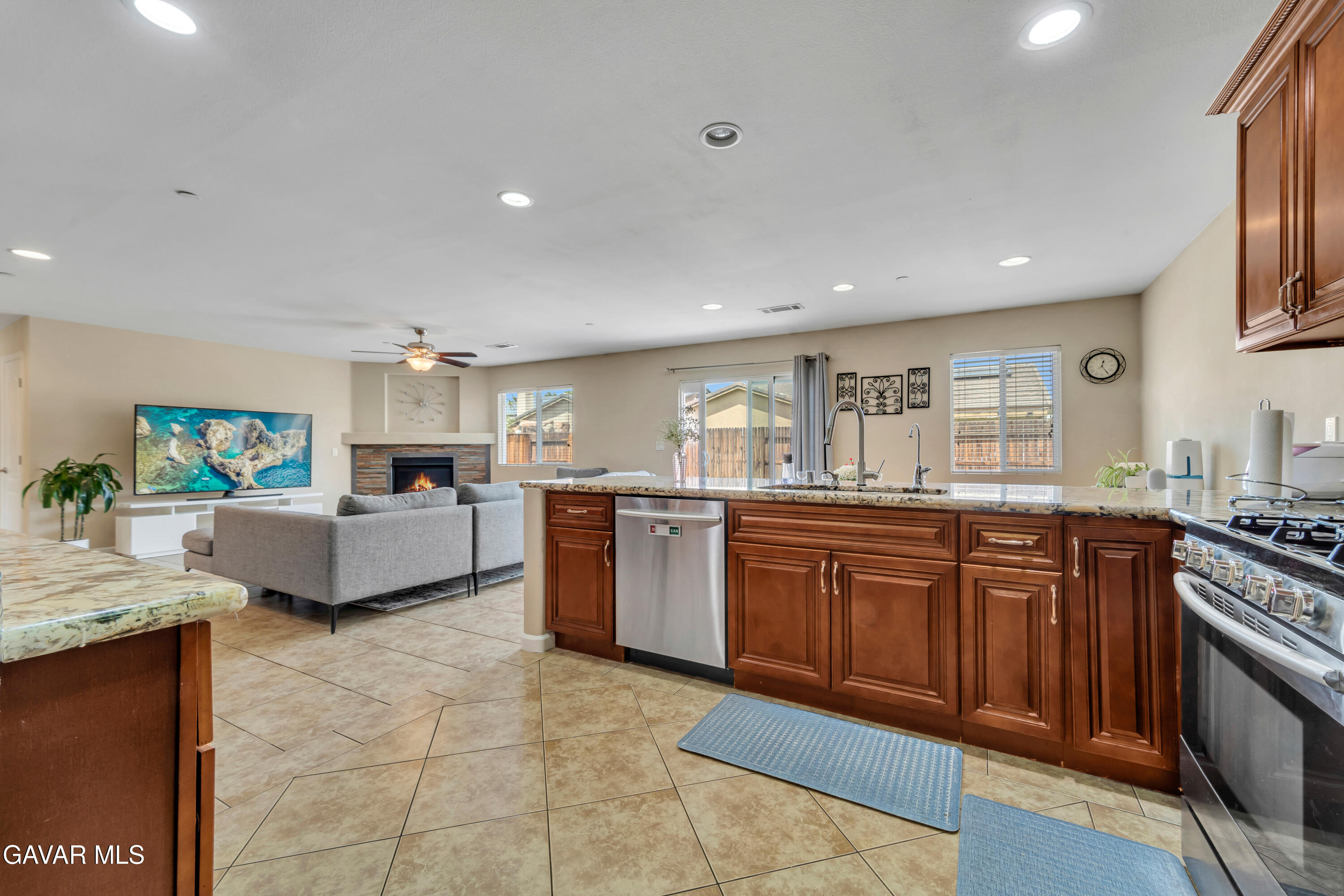 1415 Richfield Avenue Rosamond, CA 93560 - Photo 4 of 21 a large kitchen with stainless steel appliances granite countertop a stove a sink dishwasher and a refrigerator