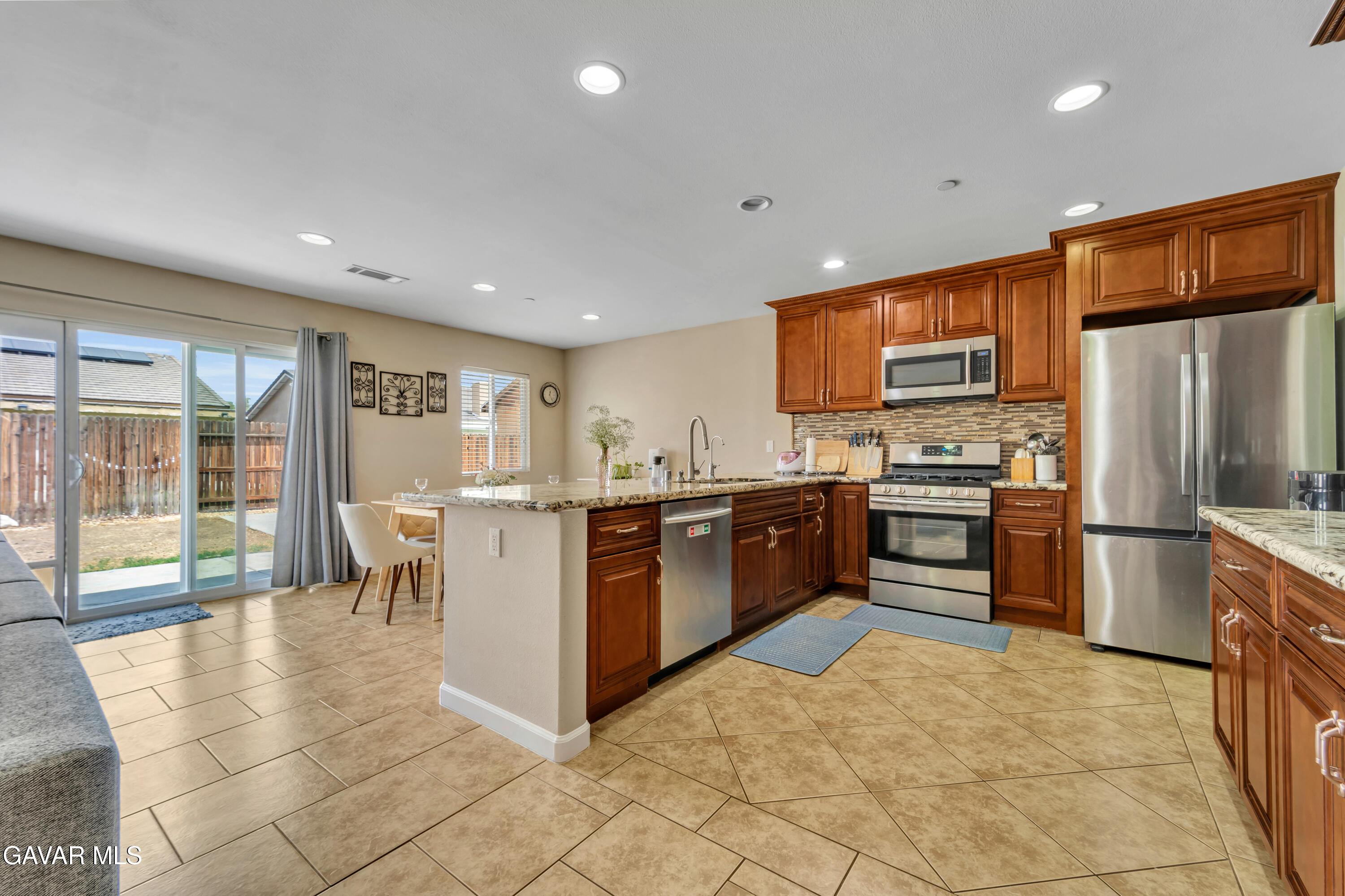 1415 Richfield Avenue Rosamond, CA 93560 - Photo 5 of 21 a kitchen with a refrigerator sink and microwave