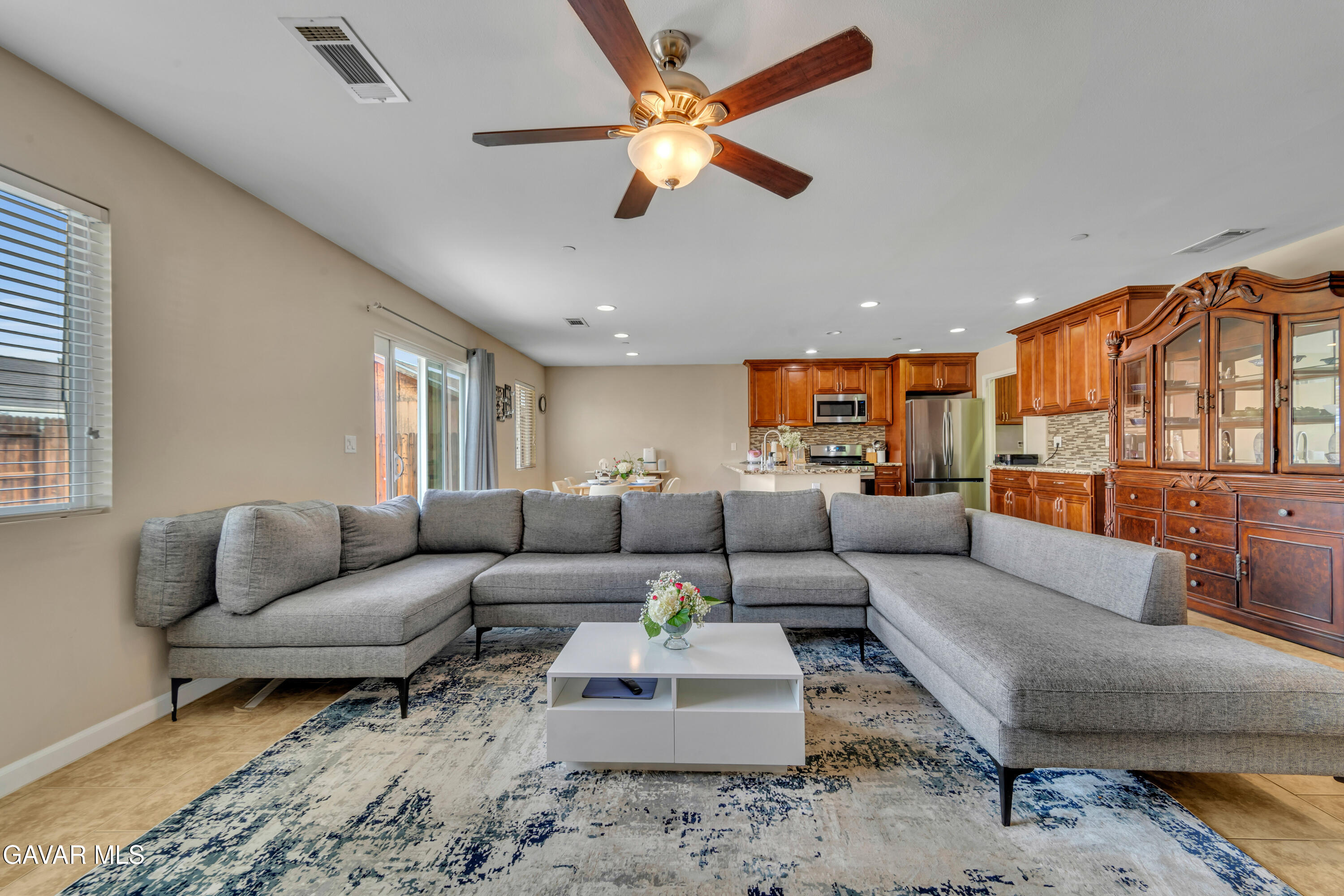 1415 Richfield Avenue Rosamond, CA 93560 - Photo 8 of 21 a living room with furniture ceiling fan and a rug