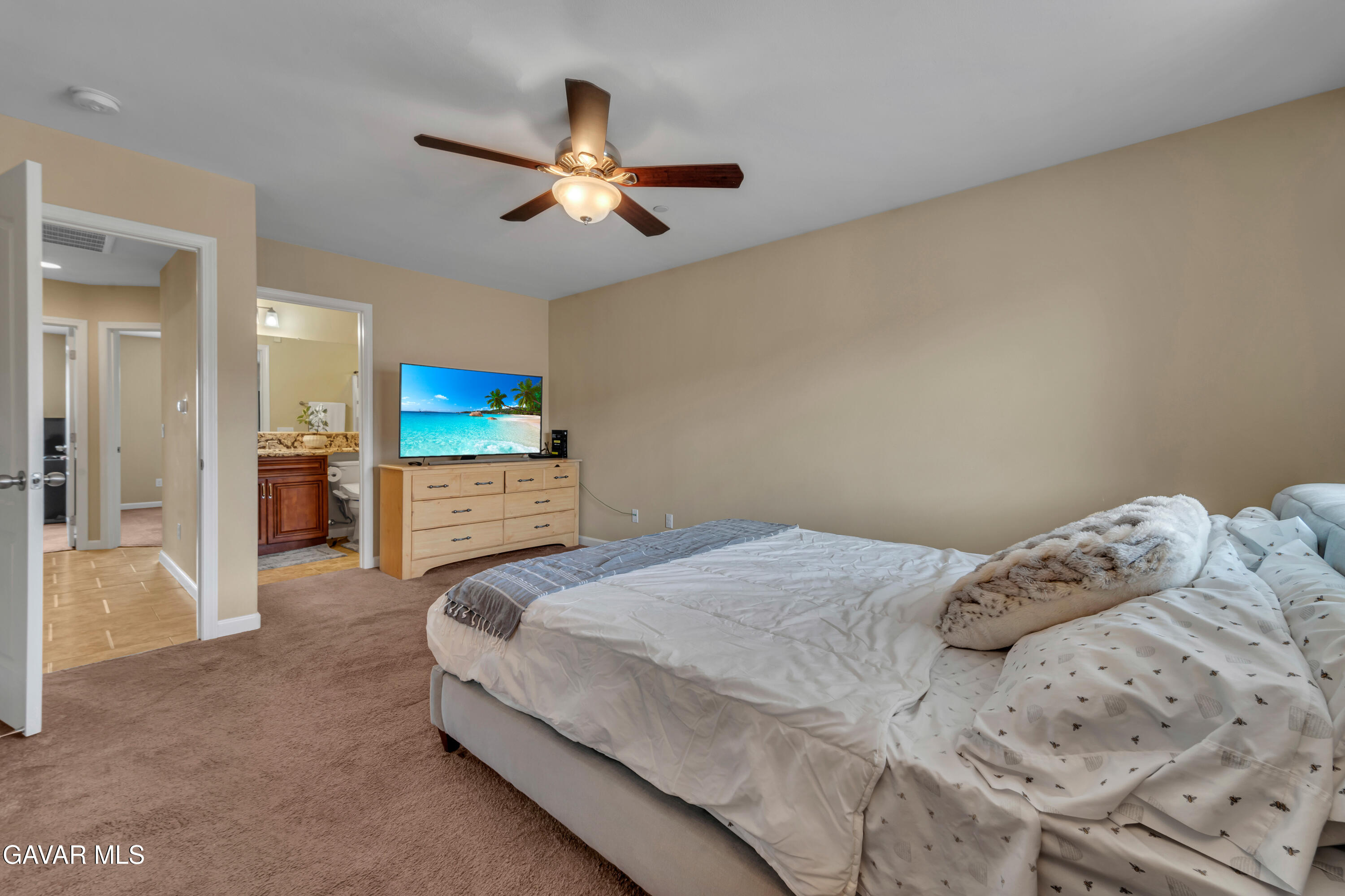1415 Richfield Avenue Rosamond, CA 93560 - Photo 9 of 21 a bedroom with a bed and a chandelier