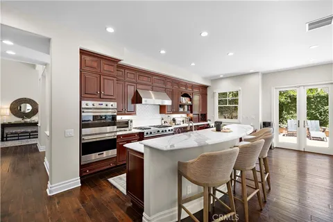 a kitchen with stainless steel appliances granite countertop a stove and a refrigerator