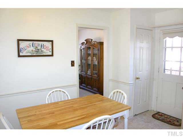 5026 Raintree Road Durham, NC 27712 - Photo 5 of 12 Spacious eat-in area in Kitchen has chair rail. This view shows the door to dining room, pantry closet and door to deck. Kitchen