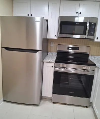a kitchen with granite countertop a sink and a stove