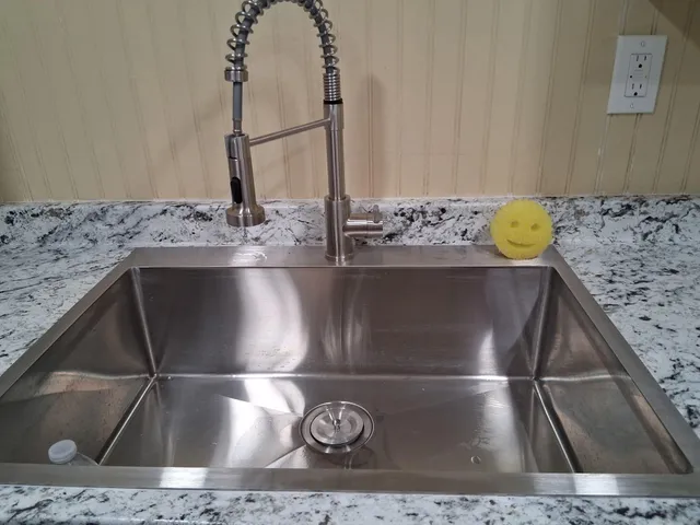 a living room with furniture kitchen view and a large window