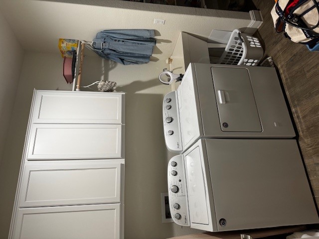 106 Calhoun Lane Georgetown, TX 78633 - Photo 12 of 16 Washroom featuring cabinet space, dark wood-style floors, and washing machine and clothes dryer