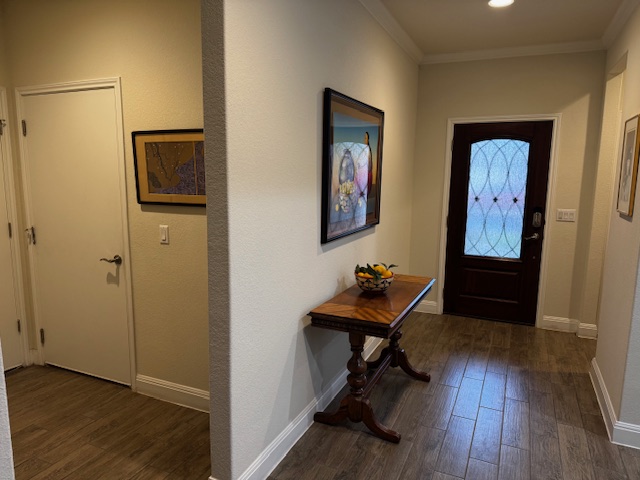 106 Calhoun Lane Georgetown, TX 78633 - Photo 4 of 16 Foyer featuring dark wood-type flooring and crown molding