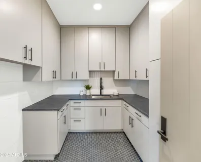 a view of an empty room with wooden floor and window