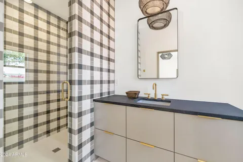 a view of an empty room with wooden floor and window