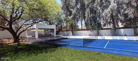 a view of a backyard with a table and chairs