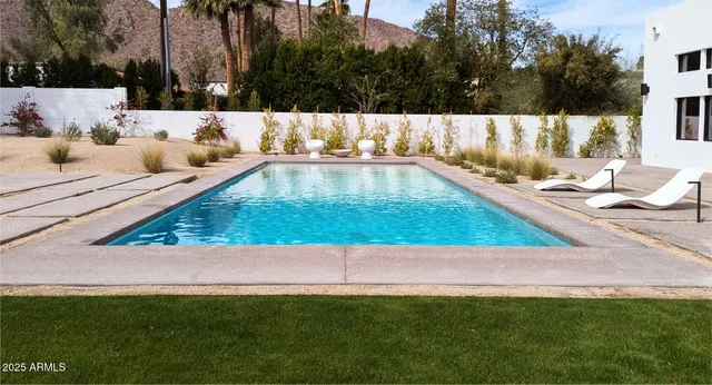 an aerial view of a house with garden space and a patio