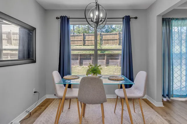a view of a dining room with furniture wooden floor and chandelier