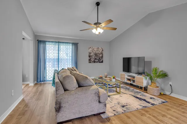 a living room with furniture and a flat screen tv