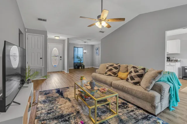a living room with furniture and a chandelier