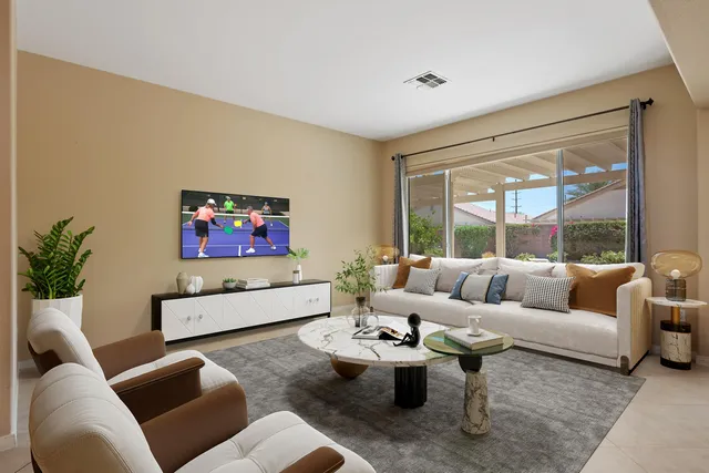 a living room with furniture and a large window