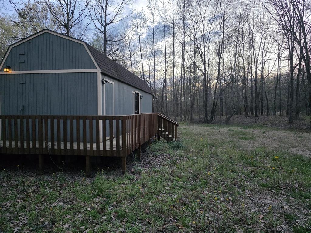 160 Zigler Road Avery, TX 75554 - Photo 4 of 14 View of home's exterior featuring a gambrel roof and a deck