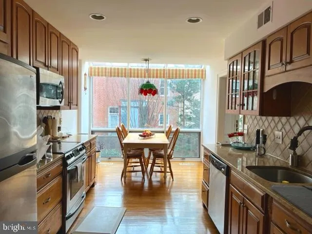 a kitchen with a table chairs stove and cabinets