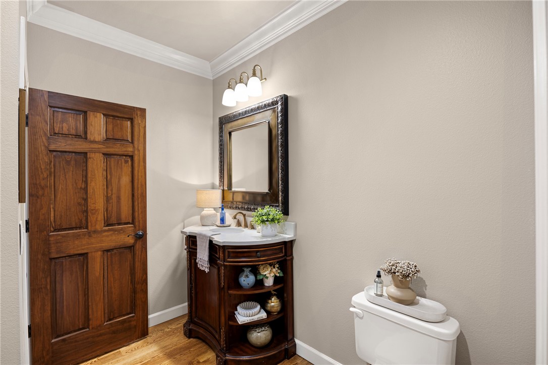788 Cliff Road Russellville, AR 72802 - Photo 20 of 60 Half bath featuring vanity, ornamental molding, and light wood-type flooring
