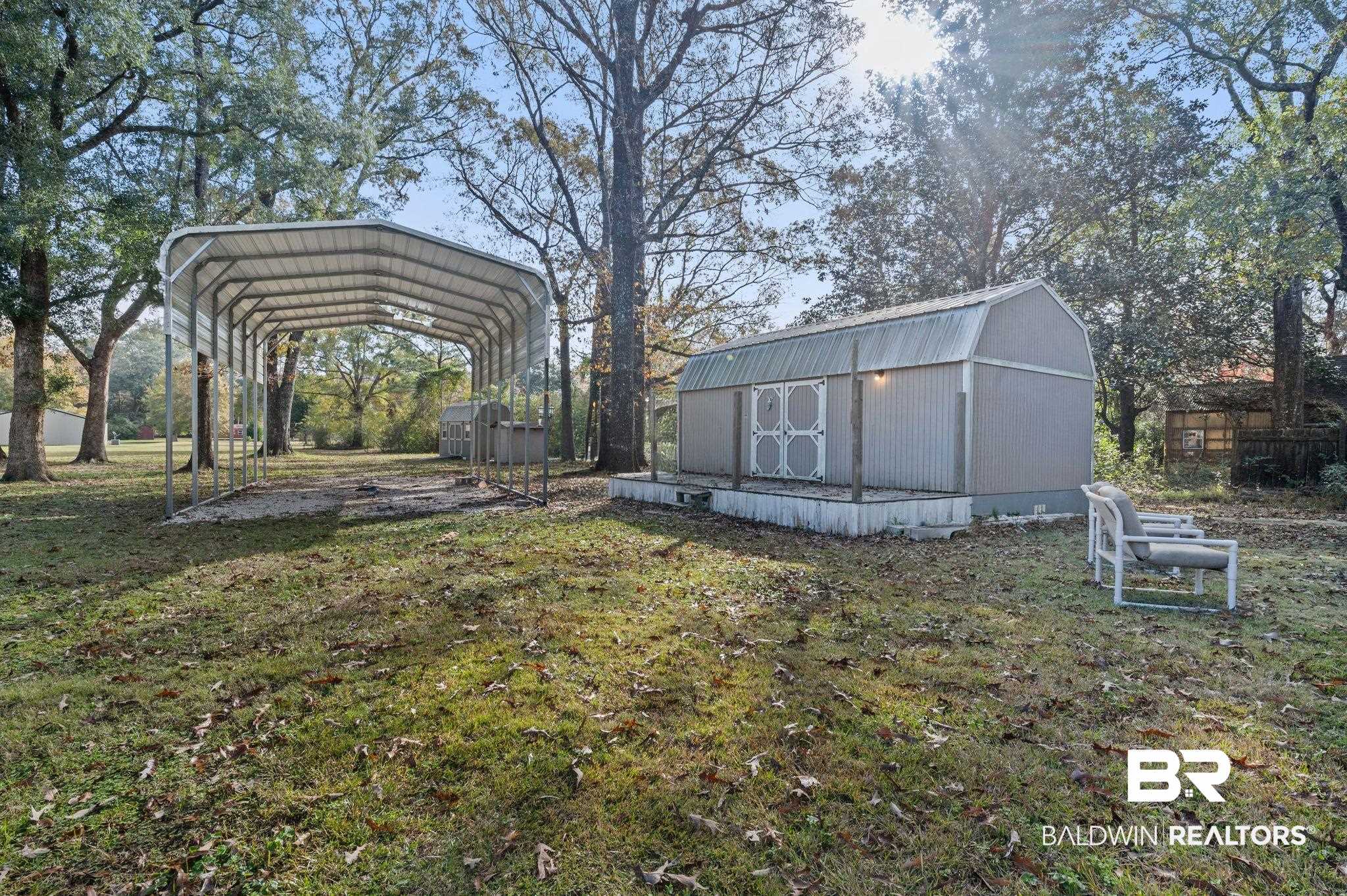 9382 D'Olive Street Bay Minette, AL 36507 - Photo 25 of 27 View of yard with a storage unit and a carport