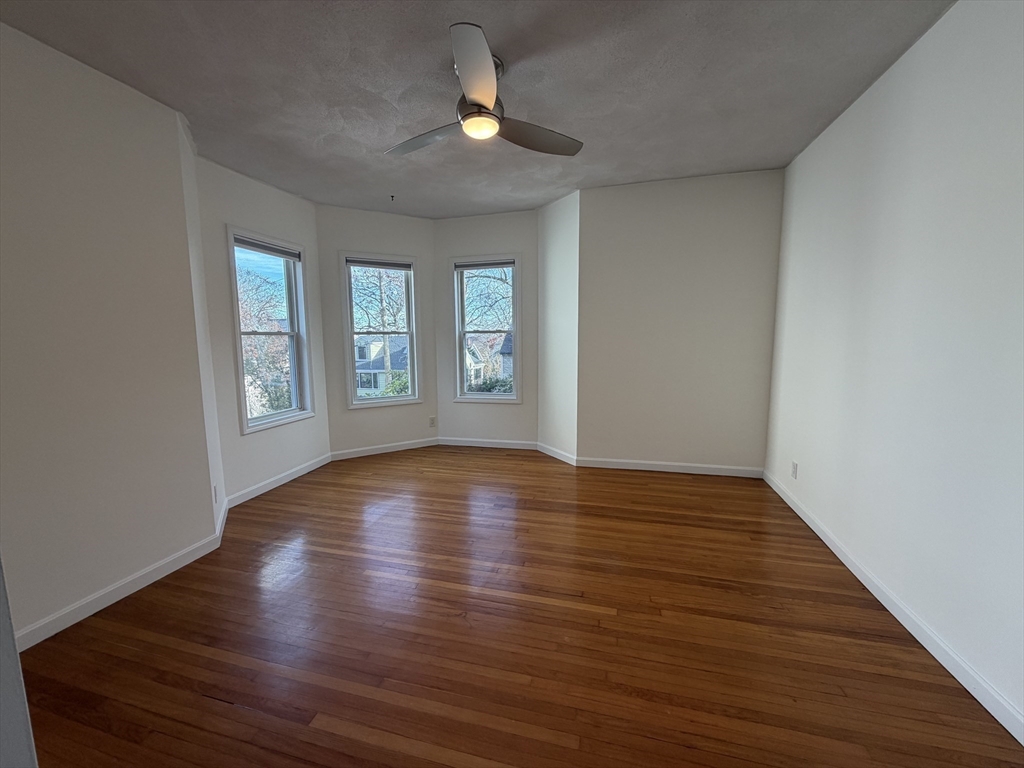 42 Fairview Street, Unit 42 Boston, MA 02131 - Photo 11 of 18 a view of an empty room with window and wooden floor
