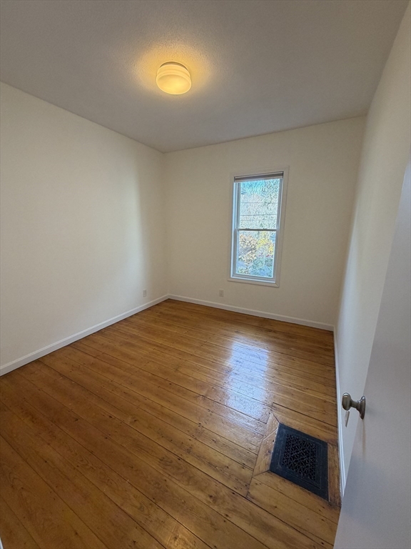 42 Fairview Street, Unit 42 Boston, MA 02131 - Photo 14 of 18 a view of empty room with wooden floor and fan