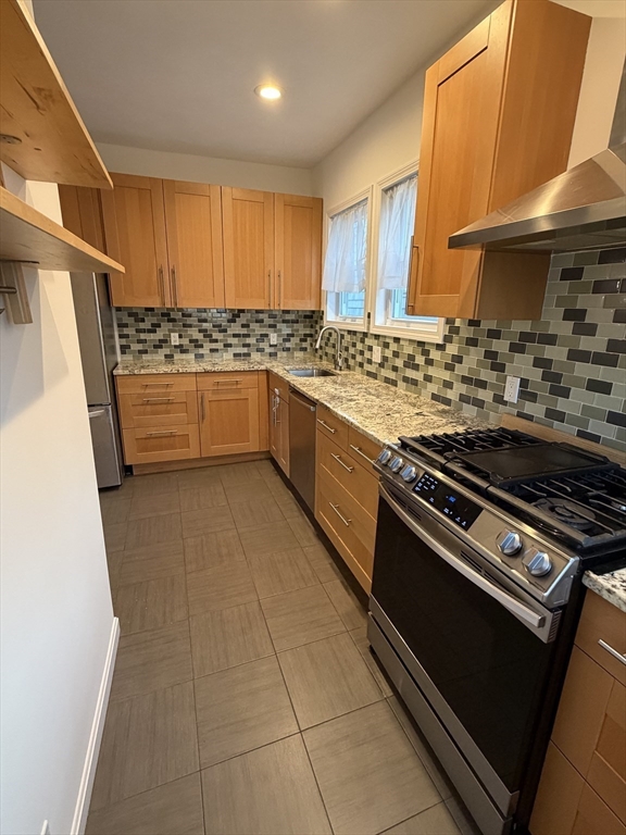 42 Fairview Street, Unit 42 Boston, MA 02131 - Photo 6 of 18 a kitchen with stainless steel appliances granite countertop a stove a sink and a microwave