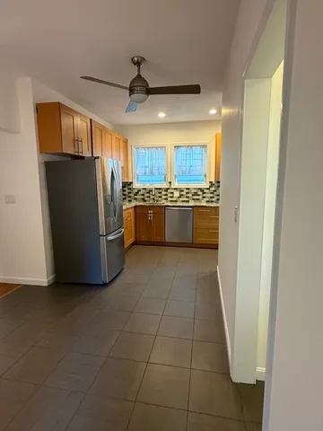 a kitchen with stainless steel appliances granite countertop a refrigerator and a sink
