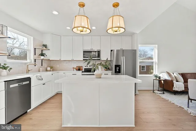a kitchen with cabinets a sink and a stove top oven