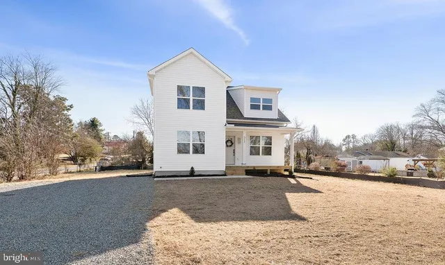 a view of a house with a yard and sitting area