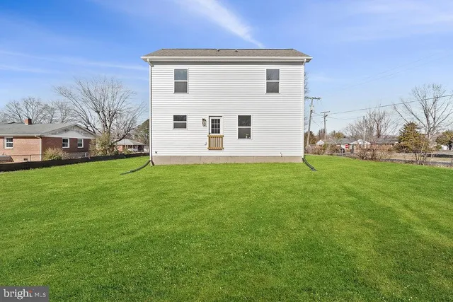 a view of a house with snow on the road