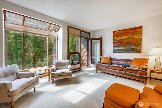 a living room with furniture and a floor to ceiling window