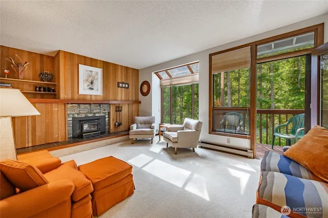 a living room with furniture a large window and a fireplace