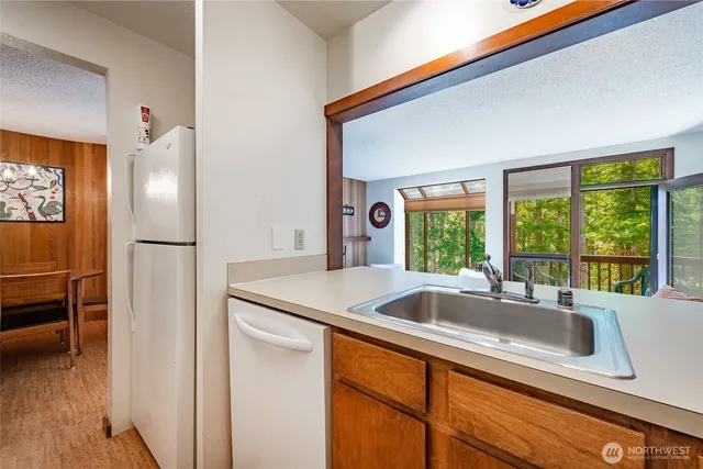 a kitchen with a sink and a refrigerator