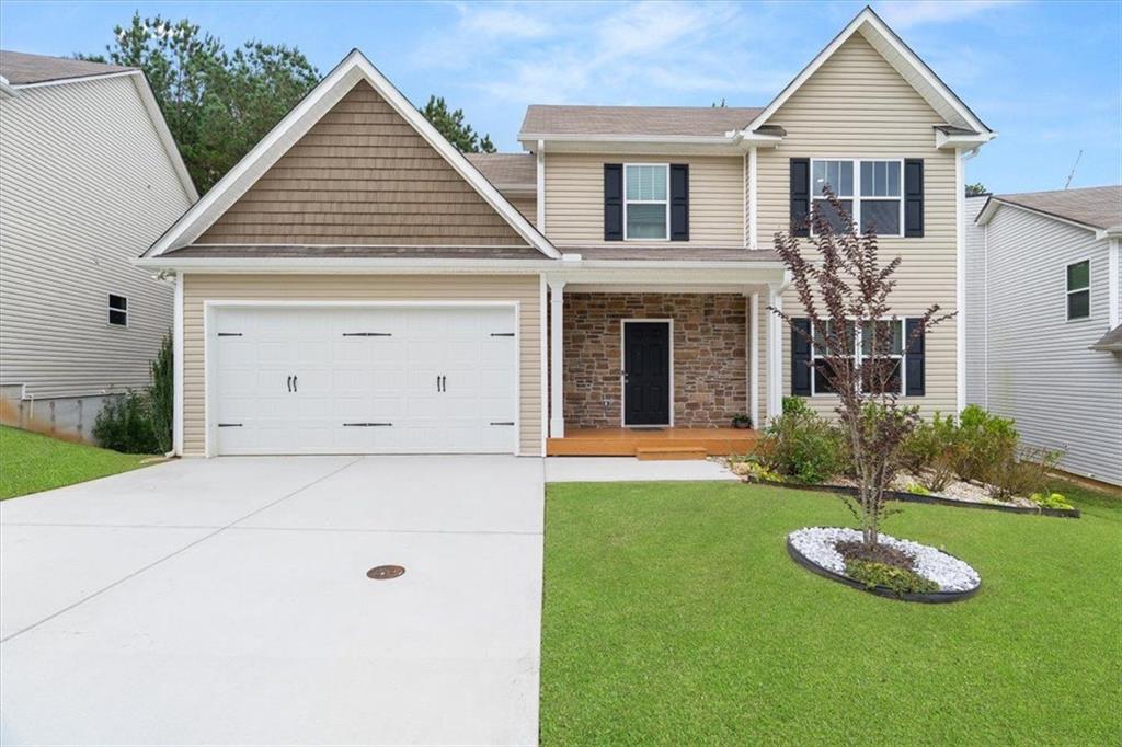 311 Fieldcrest Drive Dallas, GA 30132 - Photo 1 of 1 a view of a white house with a small yard and large trees