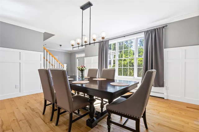 a living room with dining room and wooden floor